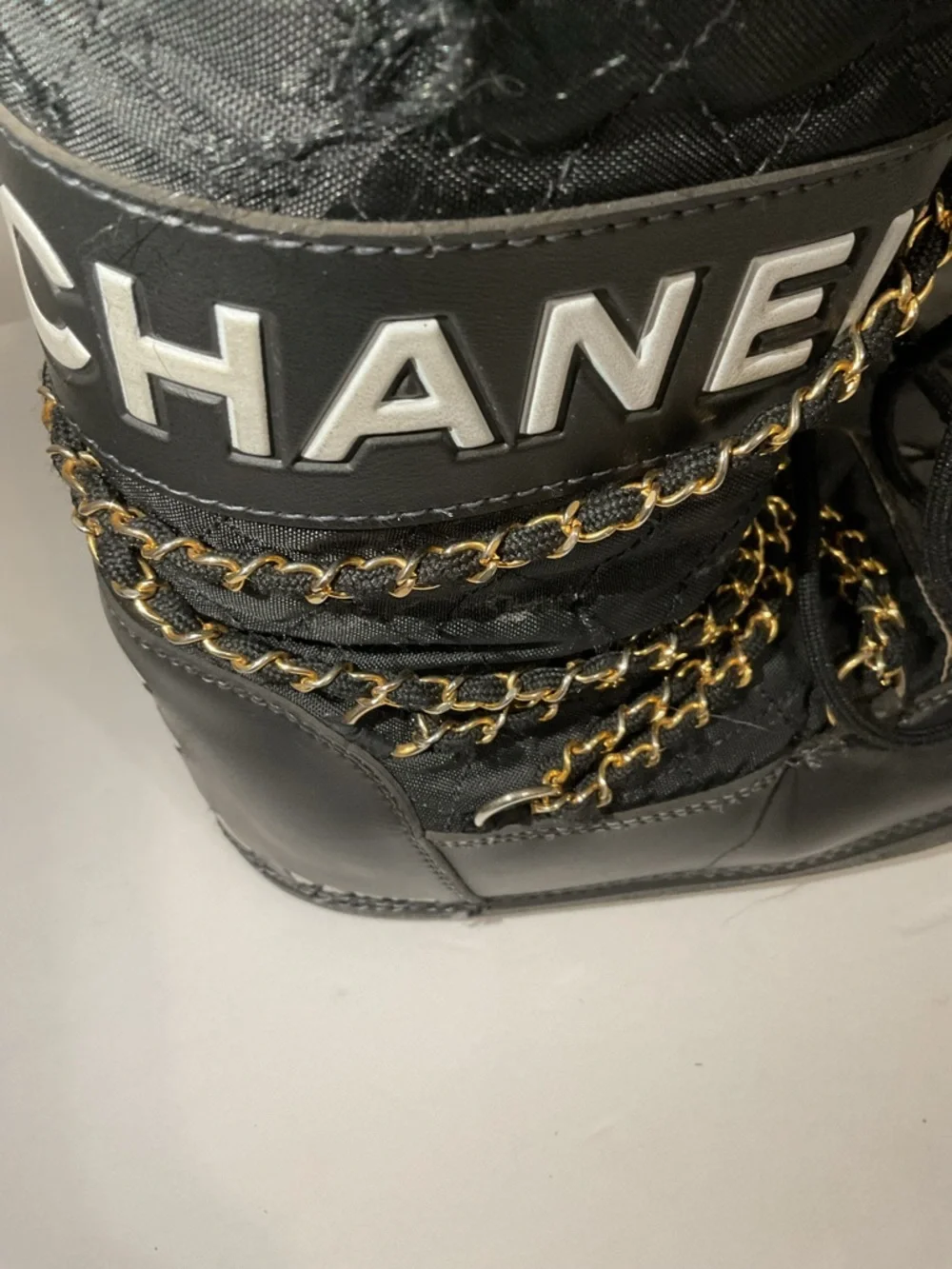 CHANEL Black and Gold Quilted Winter Lace-Up Boots